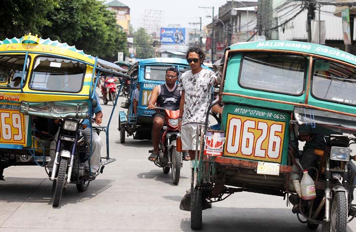 Pedicabs or tricycles ply the streets in Dumaguete City. Instead of jeepneys, tricycles dominate the public transportation area in this retirement destination. (Cheryl Baldicantos)