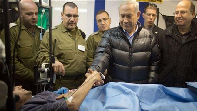 The file photo shows Israeli Prime Minister Benjamin Netanyahu shaking hands with a militant in an Israeli field hospital in Syria’s occupied Golan Heights.
